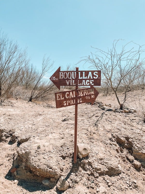 a sign with directions pointing to Boquillas village 0.5 miles away and El Calderon Spring 0.6 miles away.