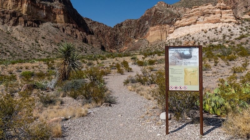 A trailhead sign and distant canyon at the Lower Burro Mesa Pouroff trailhead, on Ross Maxwell Scenic Drive