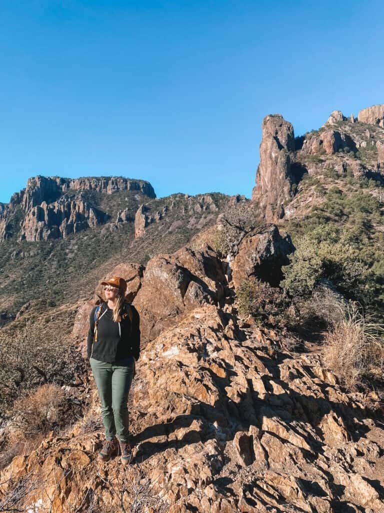 Hiker standing on rocks in the sun on the Lost Mine Trail in Big Bend