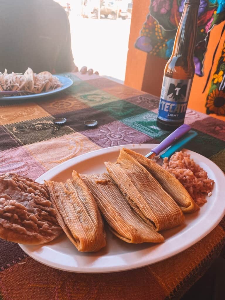 a plate of three handmade tamales, rice and beans and a cold beer at boquillas restaurant in Boquillas del Carmen, Mexico