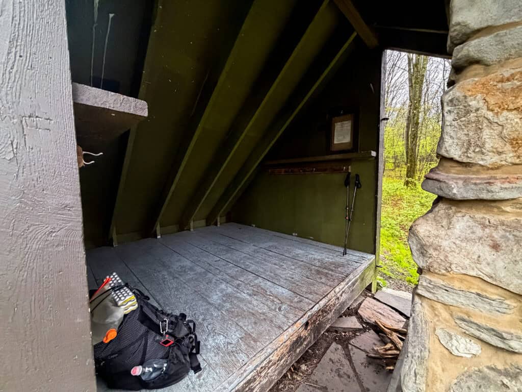 inside the shelters on the LHHT with wood floors, shelves and hooks to store gear